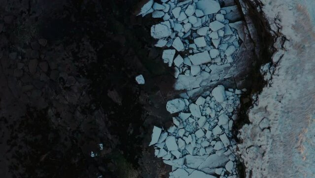 Top down bird's eye view of snow covered rocky slabs of Ireland wild atlantic way