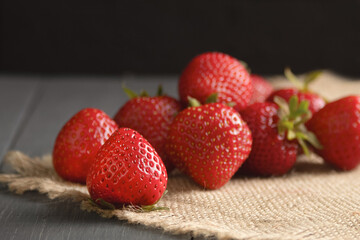 Berries of ripe, juicy strawberries. Fresh strawberries. Close-up. Wooden, rustic background. Copy space