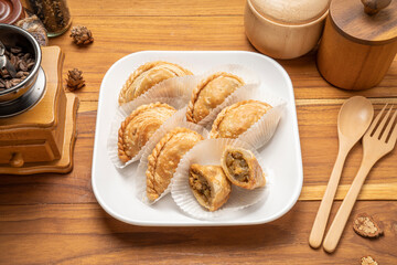Chicken Curry puff on white plate on wooden background, Curry puff pastry on wooden table.