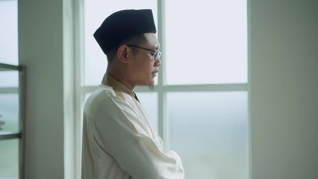 Asian moslem praying in mosque. islamic religion. During Ramadan he often prays in the mosque, worships, reads the Koran, makes dhikr, and prays to Allah. 