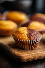 Close Up of a Muffins on cutting board on black table.