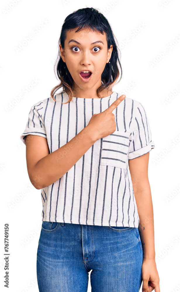 Poster Young woman wearing casual clothes surprised pointing with finger to the side, open mouth amazed expression.