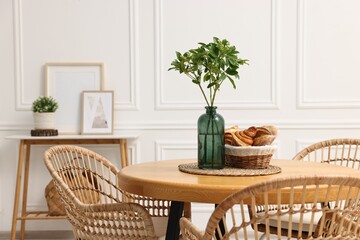 Dining room interior with comfortable furniture and plants