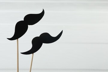 Fake paper mustaches party props on white background. Space for text