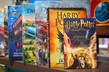 Fototapeta premium Minsk, Belarus. Mar 3, 2024. Harry Potter and the cursed child and other magical collection of Harry Potter books neatly arranged on store shelf. J. K. Rowling, Jack Thorne, and John Tiffany