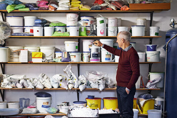 Elderly man, contractor and equipment in workshop for home improvement, maintenance and wall paint....