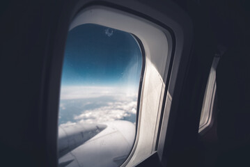Airplane window with a beautiful sky