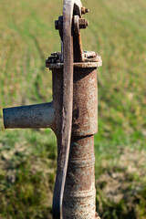 dried hand pump in middle of fields