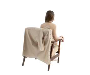 a girl with long hair and a bare back in a chair. The shirt off is on the back of the chair. draped over a chair. View from the back. the topic of gender. Isolate on transparent. PNG format available
