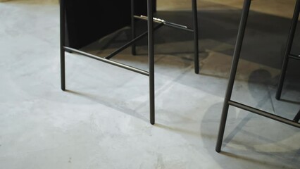 Modern bar stools on concrete and marble floors in sleek design