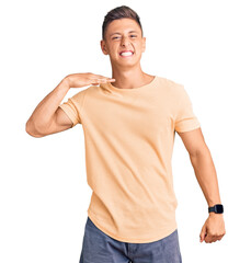Young handsome man wearing casual clothes cutting throat with hand as knife, threaten aggression...