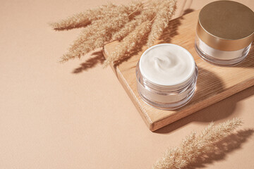Jars of cosmetic cream with pampas grass