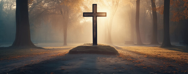 Crucifix in morning light agaisnt green autumn forest. - obrazy, fototapety, plakaty