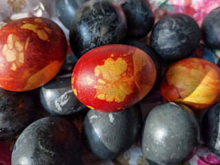 Naturally Dyed Easter Eggs, decorated with plants and flowers boiled with red cabbage, onion peels, hibiscus tea creating different colors.