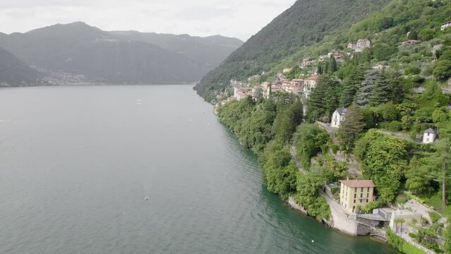 Italian Lake With Mountainside Villages In Lago di Como, Lombardy, Italy. Aerial Drone Shot