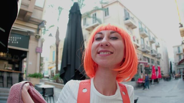 young girl with orange hair in the city. Woman in a futuristic suit. Augmented reality game, future technologies, artificial intelligence concept.