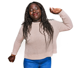 Young african woman wearing wool winter sweater stretching back, tired and relaxed, sleepy and yawning for early morning