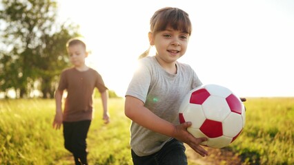 children in the park. play ball, run and team up. happy family kid dream concept. children run, play ball and learn to teamwork. children run, play ball and spend time in the park lifestyle - 767790596