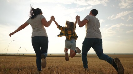 happy family. father mother and daughter together run throw up in park at sunset silhouette. people in park. happy family and little baby child summer. kid dream concept. children fun run - 767791918