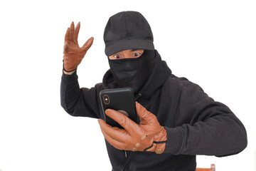 Man wearing black balaclava and hat speaking on his smrtphone