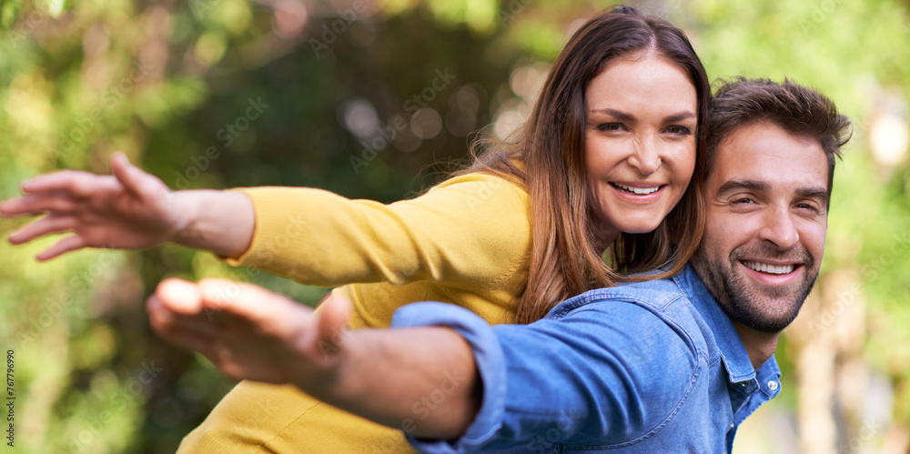 Canvas Prints Piggy back, outdoor and portrait with couple, love and smile with happiness and bonding together with romance. Face, relationship and park with man and woman with vacation and sunshine with marriage