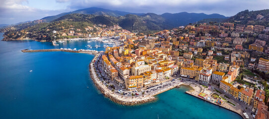 Italy , Tuscany summer destination- beautiful coastal town Porto Santo Stefano , Grosseto province. Panoramic aerial drone view - obrazy, fototapety, plakaty