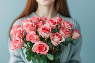 Woman with bouquet of beautiful roses on light blue background  closeup