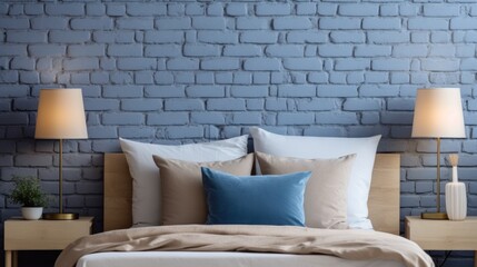 Bedroom blue pillows and beige bedding against brick wall.