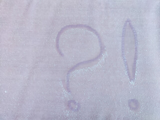 A question mark written in the snow. The cold frosty texture of the snow and the question mark. Background, place for text, copy space