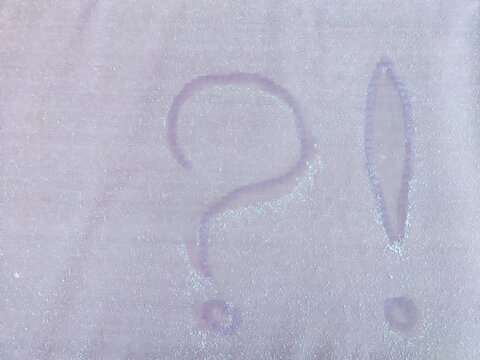 A question mark written in the snow. The cold frosty texture of the snow and the question mark. Background, place for text, copy space