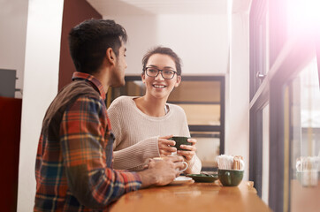 Couple, date and coffee shop with smile and talking together with hot drink in a cafe. Woman, conversation and happy from discussion and chat in a restaurant with tea or cappuccino at a table