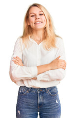 Fototapeta premium Young beautiful blonde woman wearing casual shirt happy face smiling with crossed arms looking at the camera. positive person.