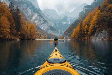 back of male kayaker kayaking on a lake with a landscape of mountain peaks and forests in nature in autumn - obrazy, fototapety, plakaty