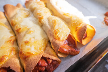 Cooked and ready to eat homemade mexican enchiladas on baking oven tray