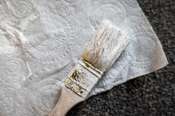 Fototapeta na wymiar Paint brush on paper tissue during home renovation