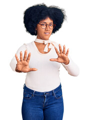 Young african american girl wearing casual clothes and glasses doing stop gesture with hands palms, angry and frustration expression