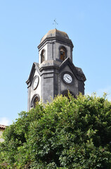 Fototapeta na wymiar Spanish Stone Church Tower with Cupola and Clock seen from Below