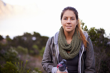 Woman, hiking and outdoor for portrait with bottle for water with fitness, hydration or smile on...