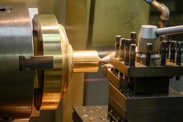 The lathe machine finish cut the brass material parts by lathe tools.