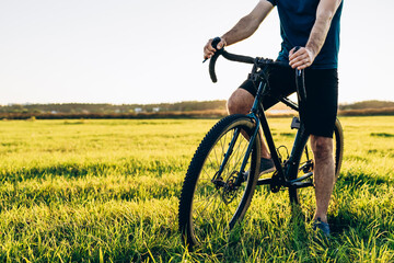 Mountain biker cycling a bike during a sunset outside. Healthy lifestyle and outdoor adventure...