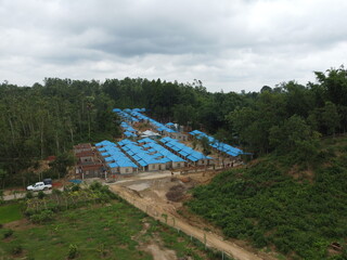 A bunch of Houses with blue roofs on the hill.