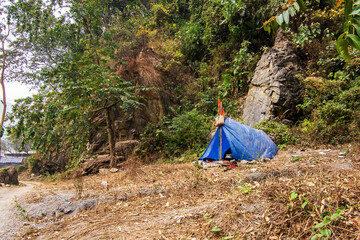5th March, 2024, Jayanti river, Buxe tiger reserve, Alipur Duar, West Bengal, India: A devotee staying at temporary tented camp near Mahakaal cave at Buxa Jayanti on the ocation od Maha Shiv Ratri.