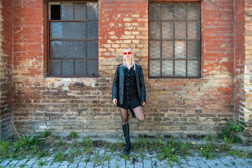 Young beautiful strong independent rebel blonde woman Punk music and style fan posing. Confident Punk-Rock youth culture street style concept. Cool attitude bee different concept