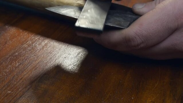 Full frame close up: Classic Viking axe head is sharpened with stone