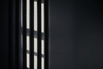 Abstract black background with geometric vertical slats, backdrop with copy space, light and shadow pattern. Stylish template, mock up for your design, art, poster, presentation.