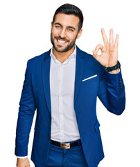 Young hispanic man wearing business jacket smiling positive doing ok sign with hand and fingers....