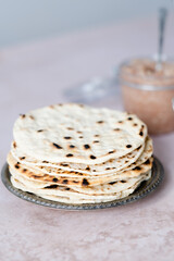 Handmade round matzo in a plate. Sweet condiment with apple-walnut charoset on the table. Healthy food. Jewish Passover celebrations. space for text.