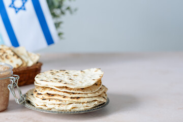 Handmade round matzo in a plate. Sweet condiment with apple-walnut charoset on the table. Healthy food. Jewish Passover celebrations. space for text