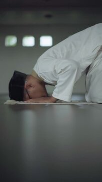 Asian moslem praying in mosque. islamic religion. During Ramadan he often prays in the mosque, worships, reads the Koran, makes dhikr, and prays to Allah.