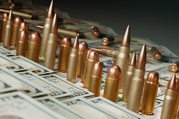 Shiny Bullets on a of US Dollar Bills The Intersection of Finance and Warfare - obrazy, fototapety, plakaty